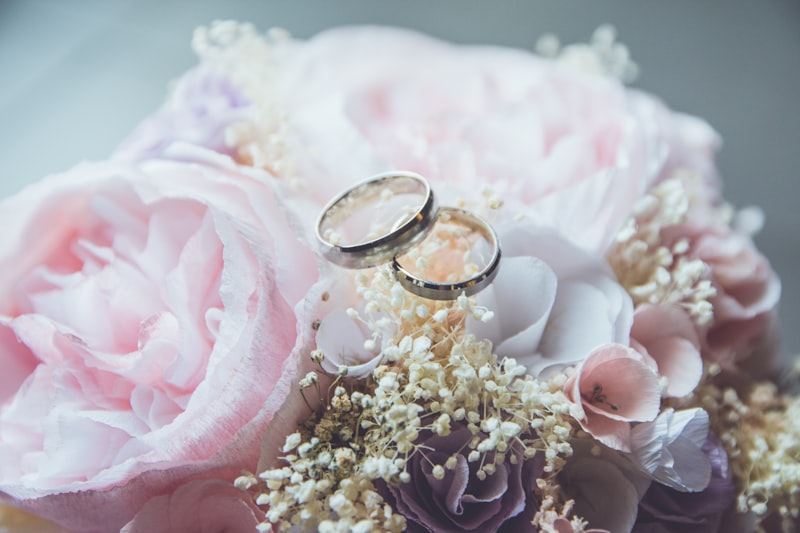 Bride and groom holding hands close-up